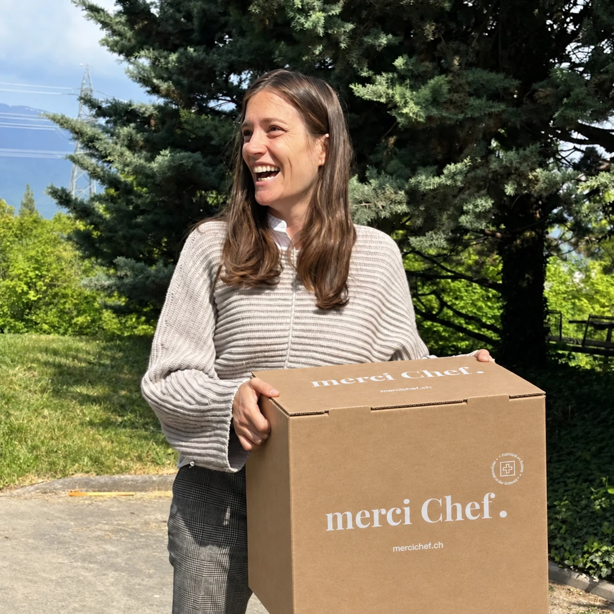 Illya with a merciChef delivery box outdoors
